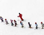 Lots of children skiing