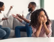 Child looking sad as parents argue