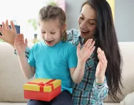 Mother and child opening gift
