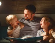 Dad reading with children
