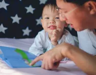 child reading with father