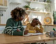 Mother helping child with homework BigStock image