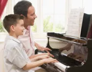 Boy having piano lesson