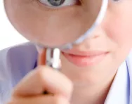 Boy looking through a magnifying glass