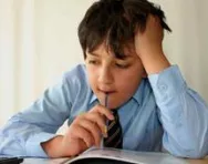 Boy puzzling over book