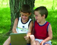 Boys giggling over a book