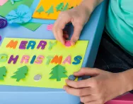 Child making a Christmas card