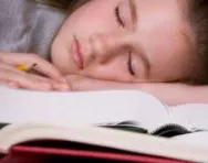 Child asleep on their desk