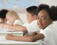 Children writing in classroom