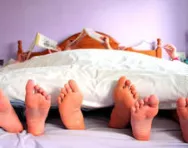 Family relaxing in bed