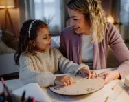 Mother and daughter with clock