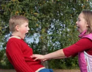 Girl pushing boy playfully