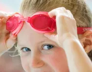 Girl in primary school wearing swimming goggles