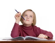 Girl chewing pencil thinking