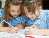 Schoolgirls writing