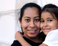 image of mother and daughter looking happy