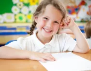 Little girl in classroom smiling