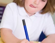 Little girl writing out numbers