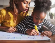 Mother and daughter writing