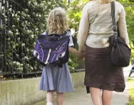 Mum and daughter walking to school