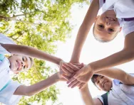 Schoolchildren stacking hands