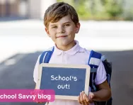 School child holding chalkboard
