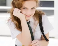 Secondary school girl with stack of books