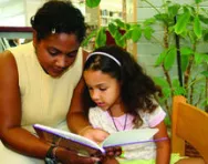 Teacher reading with pupil