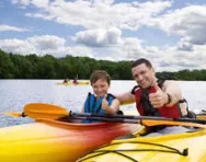 Child learning to canoe