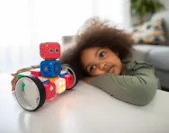 Child playing with science toy photo by Robo Wunderking 