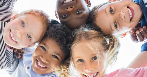 Children in a circle smiling