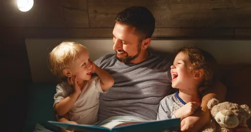 Dad reading with children