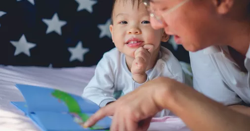 child reading with father