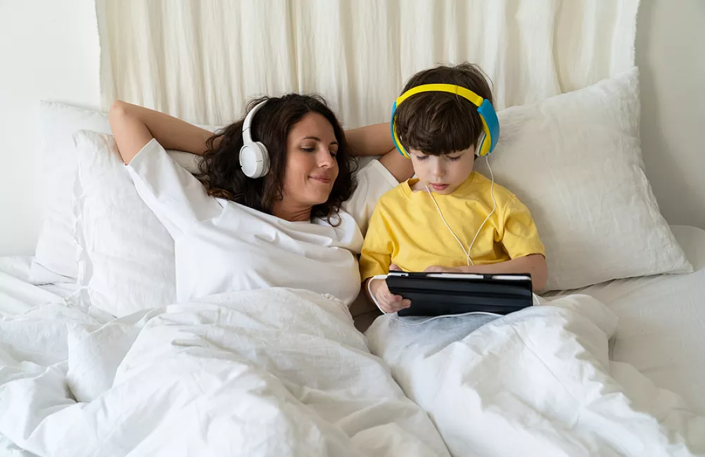 Bigstock mother and son listening in bed