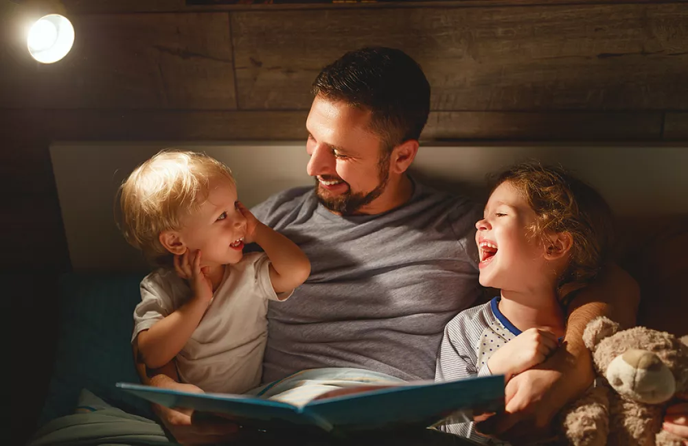 Dad reading with children