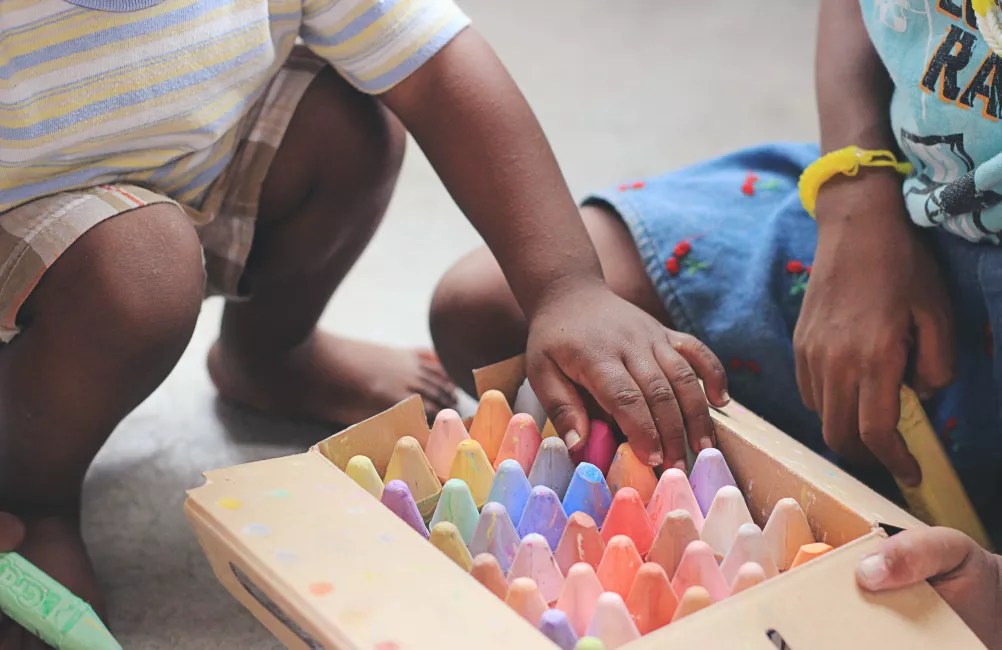 Child picking crayons Tina Floersch unsplash